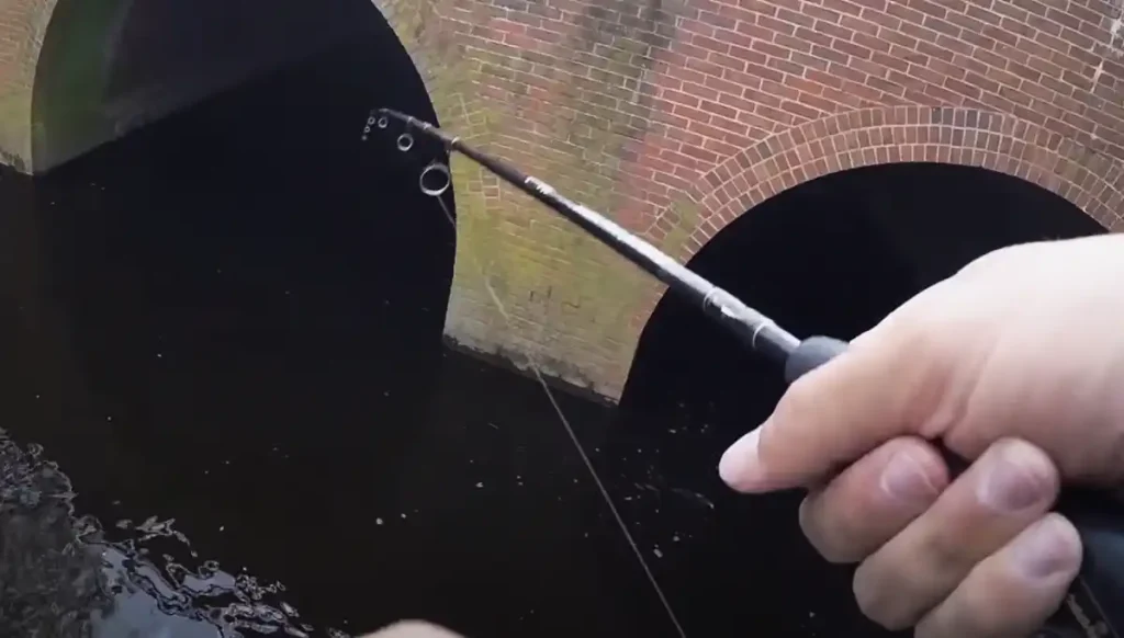 Baiting for fish near a bridge shade